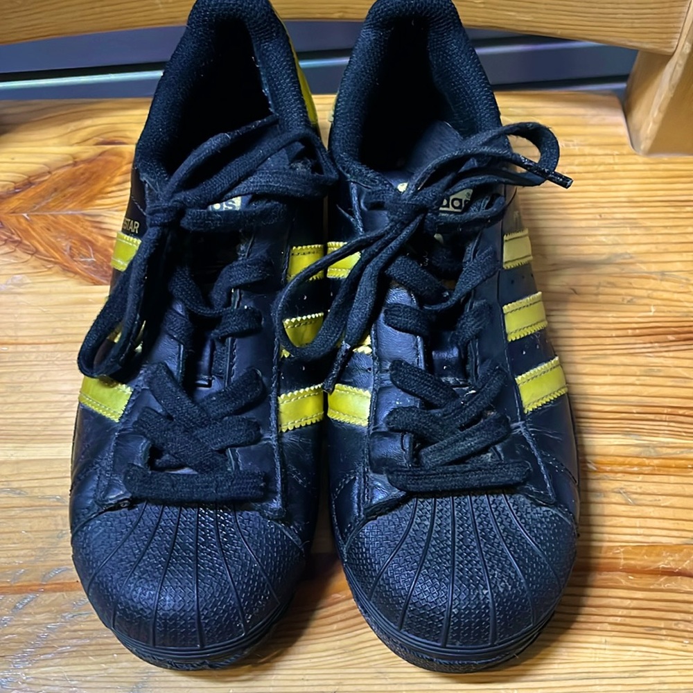 Adidas Superstars in Black and Gold, size 4 US.